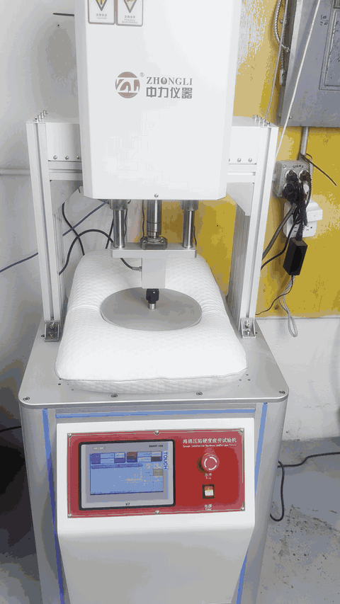 Maple Sleep pillow undergoing a lab compression test.